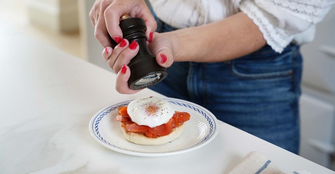 Adding pepper to the poached egg