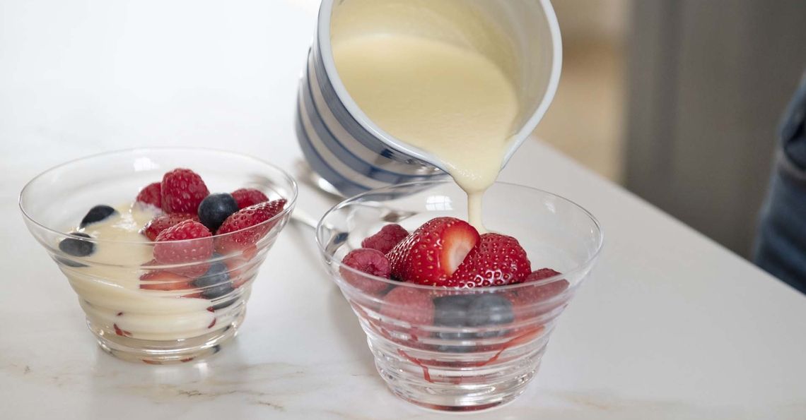 Pouring egg custard onto fruit