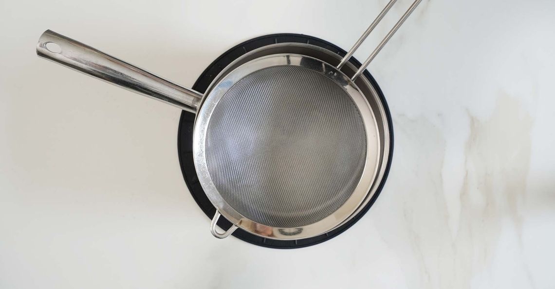 Straining the egg custard mixture