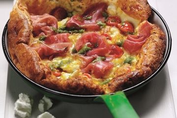 Savoury pancake puff with Parma ham, tomatoes, feta and pesto